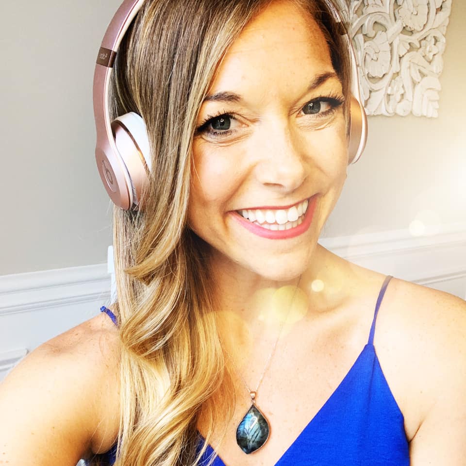 Woman smiling with pink headset on